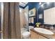 Beautiful bathroom featuring blue walls, granite countertop, decorative shower curtain and tub with tiled wall surround at 1273 Promontory Ln, Marietta, GA 30062