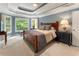 Large bedroom with tray ceiling, large windows, a plush bed, and neutral color palette at 1273 Promontory Ln, Marietta, GA 30062