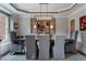 Formal dining room with modern chandelier, complemented by a large window and sophisticated decor at 1273 Promontory Ln, Marietta, GA 30062