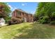 A spacious backyard with a well-maintained lawn complements this classic brick home's inviting exterior at 1273 Promontory Ln, Marietta, GA 30062
