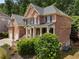 Charming two-story brick home with a well-manicured lawn and mature trees offering classic curb appeal at 1273 Promontory Ln, Marietta, GA 30062