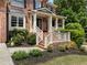 Inviting front porch with brick steps, lush landscaping, and elegant white railings, perfect for relaxing at 1273 Promontory Ln, Marietta, GA 30062