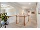 Upstairs hallway with white railings, neutral carpet, and decorative plant on table at 1273 Promontory Ln, Marietta, GA 30062