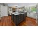 Open kitchen with hardwood floors, an island and view to the living room with fireplace at 1273 Promontory Ln, Marietta, GA 30062