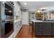 Gourmet kitchen featuring stainless steel appliances, island with bar seating, and view to living area at 1273 Promontory Ln, Marietta, GA 30062