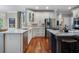 Kitchen featuring stainless steel appliances, an island with bar seating and hardwood floors at 1273 Promontory Ln, Marietta, GA 30062