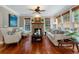 Comfortable living room with stone fireplace, ceiling fan, wood floors and natural light at 1273 Promontory Ln, Marietta, GA 30062
