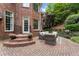 Outdoor patio with brick pavers, stylish wicker furniture, and professional landscaping creates a relaxing space at 1273 Promontory Ln, Marietta, GA 30062