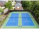 Aerial view of two well-maintained blue and green tennis courts within the community at 1273 Promontory Ln, Marietta, GA 30062