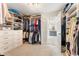 Large walk-in closet with extensive shelving and custom storage that leads to the bathroom at 1273 Promontory Ln, Marietta, GA 30062