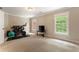 Spacious workout room featuring natural light, a stationary bike, and ample space for exercise equipment at 1273 Promontory Ln, Marietta, GA 30062