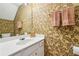 A well-lit half bathroom with a vanity that includes a white sink and decorative wallpaper at 4004 Edgecomb Dr, Roswell, GA 30075
