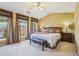 A well-lit bedroom with a plush bed, complemented by matching nightstands and bench seating at 4004 Edgecomb Dr, Roswell, GA 30075