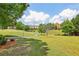 Well-manicured community green space with walking paths and mature trees at 4004 Edgecomb Dr, Roswell, GA 30075