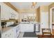 Functional kitchen with stainless steel appliances, white cabinetry, and a view to the living room at 4004 Edgecomb Dr, Roswell, GA 30075