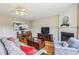 Open-concept living area with fireplace, hardwood floors and seamless flow to dining area at 4004 Edgecomb Dr, Roswell, GA 30075