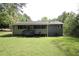 View of a large backyard with a screened porch and an air conditioning unit at 443 Indian Hills Dr, Dallas, GA 30157