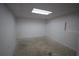 Small unfinished basement with white painted walls, concrete floor, and drop ceiling with light at 443 Indian Hills Dr, Dallas, GA 30157