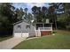 Charming home with gray siding, white trim, a front porch and an attached two-car garage at 443 Indian Hills Dr, Dallas, GA 30157
