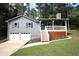 Charming home with gray siding, white trim, a front porch and an attached two-car garage at 443 Indian Hills Dr, Dallas, GA 30157