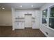 A bright kitchen featuring white cabinets and a dining area with lots of light at 443 Indian Hills Dr, Dallas, GA 30157