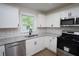A bright kitchen featuring white cabinets, stainless steel appliances, and granite countertops at 443 Indian Hills Dr, Dallas, GA 30157