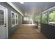 Covered porch with wooden floors and gray siding at 443 Indian Hills Dr, Dallas, GA 30157