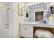 Charming bathroom featuring a tub with shower and a vanity with a lighted mirror and a fluffy ottoman at 8740 Roswell Rd # 9C, Atlanta, GA 30350
