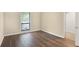 Bedroom with gleaming laminate floors and a window overlooking the outdoors, adjacent to a closet at 8740 Roswell Rd # 9C, Atlanta, GA 30350