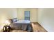 Comfortable bedroom with a full size bed, hardwood floors, and a bright window at 8740 Roswell Rd # 9C, Atlanta, GA 30350