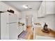 Efficient kitchen with white appliances, warm countertops, and a view to the living space at 8740 Roswell Rd # 9C, Atlanta, GA 30350