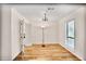 Open-concept space with hardwood floors, a chandelier, and a large window, with a view into the kitchen at 8740 Roswell Rd # 9C, Atlanta, GA 30350