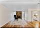 Open-concept living room showcasing a stone fireplace and hardwood floors, with a view into the kitchen at 8740 Roswell Rd # 9C, Atlanta, GA 30350