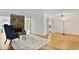 Inviting living room featuring a stone fireplace, hardwood floors, and views of the balcony and kitchen at 8740 Roswell Rd # 9C, Atlanta, GA 30350