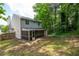 The backyard features a screened-in porch and mature trees at 1034 Hillsborough Nw, Kennesaw, GA 30144