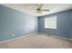 Bedroom with blue walls, ceiling fan and one window at 1034 Hillsborough Nw, Kennesaw, GA 30144