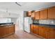 Spacious kitchen with wood cabinets, tile backsplash, and an open layout with natural light at 1034 Hillsborough Nw, Kennesaw, GA 30144