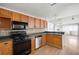 Well-lit kitchen featuring wood cabinetry, modern appliances, and an open layout at 1034 Hillsborough Nw, Kennesaw, GA 30144
