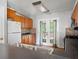 Functional kitchen featuring wood cabinets, black countertops, and a view of the backyard at 1034 Hillsborough Nw, Kennesaw, GA 30144