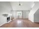Open living room featuring wood floors, vaulted ceiling, and a cozy fireplace at 1034 Hillsborough Nw, Kennesaw, GA 30144