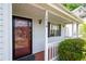 Close-up of front door with covered porch and visible house number, enhancing curb appeal at 1034 Hillsborough Nw, Kennesaw, GA 30144