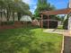 Beautiful back yard with green grass, wood dividers, and shade, perfect for outdoor enjoyment at 1692 Woodsford Nw Rd, Kennesaw, GA 30152