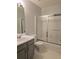 Bathroom featuring modern sliding glass shower doors and a white vanity at 1692 Woodsford Nw Rd, Kennesaw, GA 30152