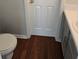 Cozy bathroom with hardwood floors and a toilet at 1692 Woodsford Nw Rd, Kennesaw, GA 30152
