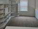 Bright bedroom featuring carpet floors and built in bookshelves, creating cozy space at 1692 Woodsford Nw Rd, Kennesaw, GA 30152