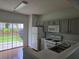 Functional kitchen featuring modern appliances, ample cabinet space, and access to the backyard at 1692 Woodsford Nw Rd, Kennesaw, GA 30152