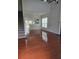 Bright living room with hardwood floors, large windows, and open layout leading to the kitchen at 1692 Woodsford Nw Rd, Kennesaw, GA 30152