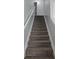 Carpeted staircase with white trim and neutral gray walls leading to the upper level at 1692 Woodsford Nw Rd, Kennesaw, GA 30152
