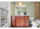 Bright bathroom featuring a wood vanity, toilet, and a tiled shower-tub combination with a window view at 2268 Limehurst Ne Dr # 120, Atlanta, GA 30319