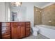 Bathroom featuring a brown vanity with a marble countertop, decorative mirror, and tile backsplash in the shower and tub at 2268 Limehurst Ne Dr # 120, Atlanta, GA 30319